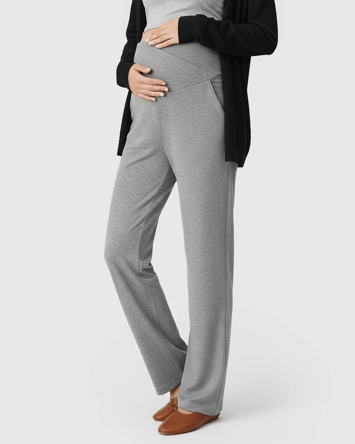 Pregnant woman in gray crossover waist wide-leg maternity lounge pants with side pockets.