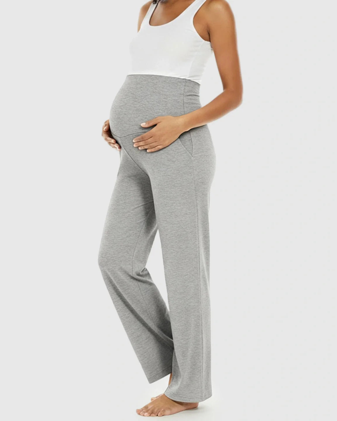Pregnant woman in gray wide-leg maternity lounge pants with a foldable waistband and side pockets.