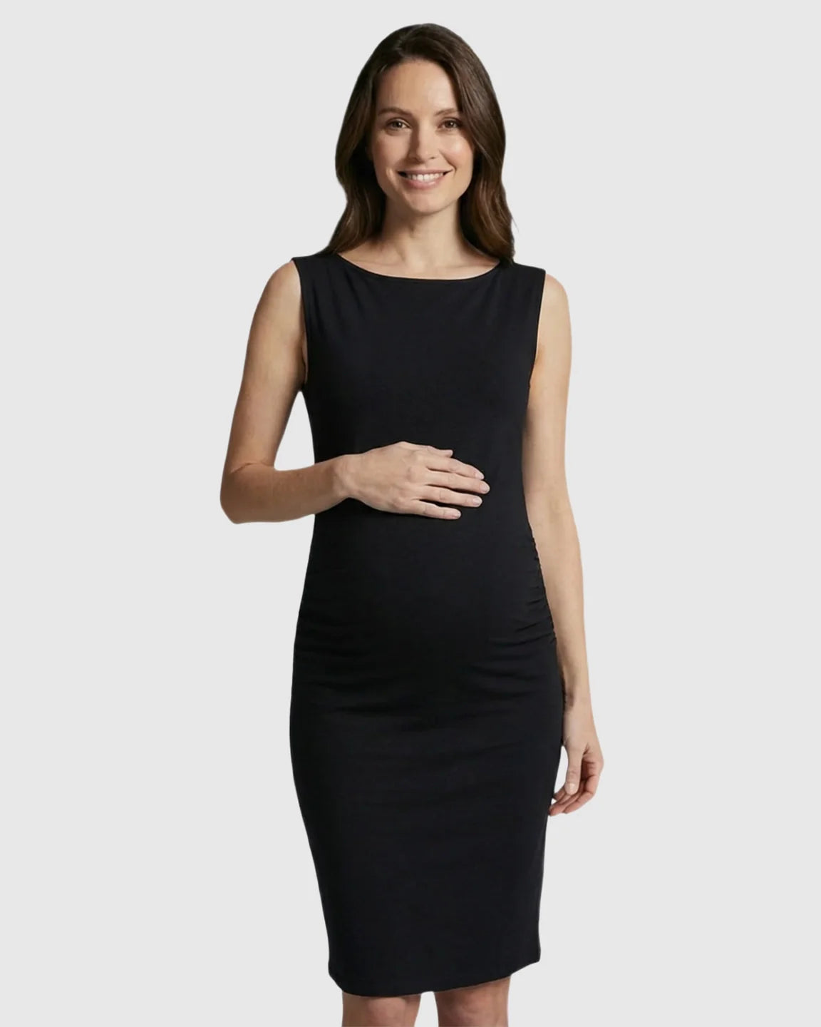 Smiling pregnant woman in a black sleeveless bodycon maternity midi dress with a boat neck.