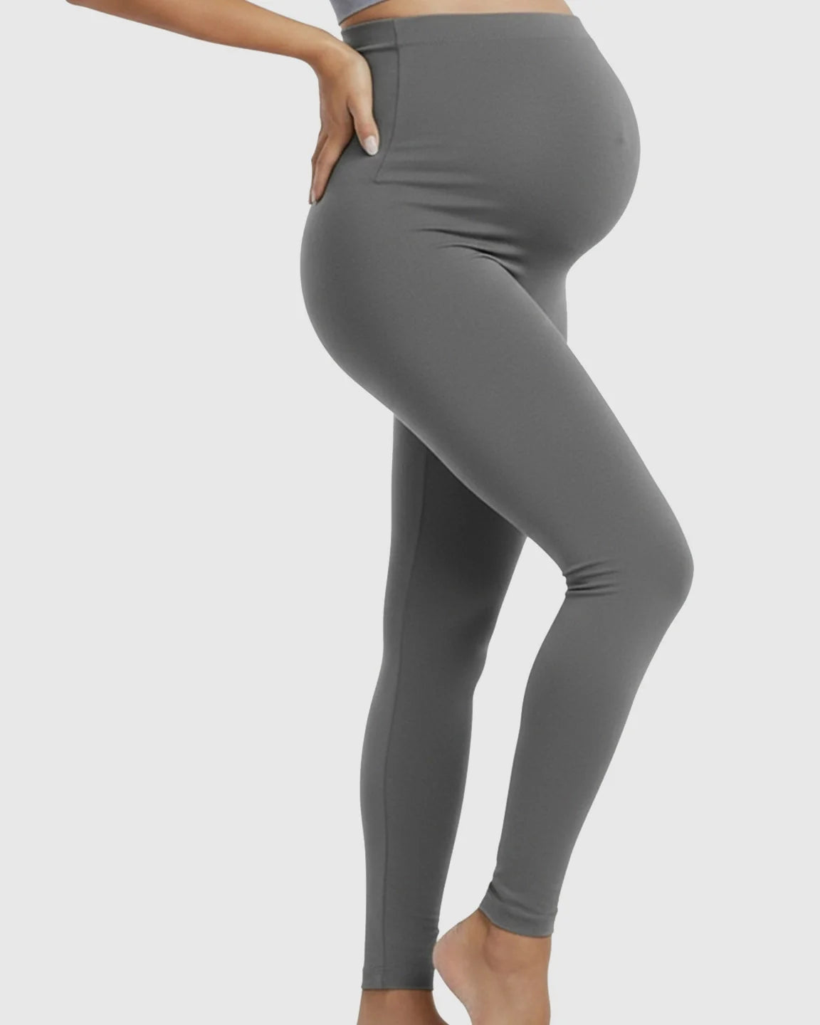 Gray high-waist maternity support leggings on a pregnant model, showcasing the full-length, seamless design.
