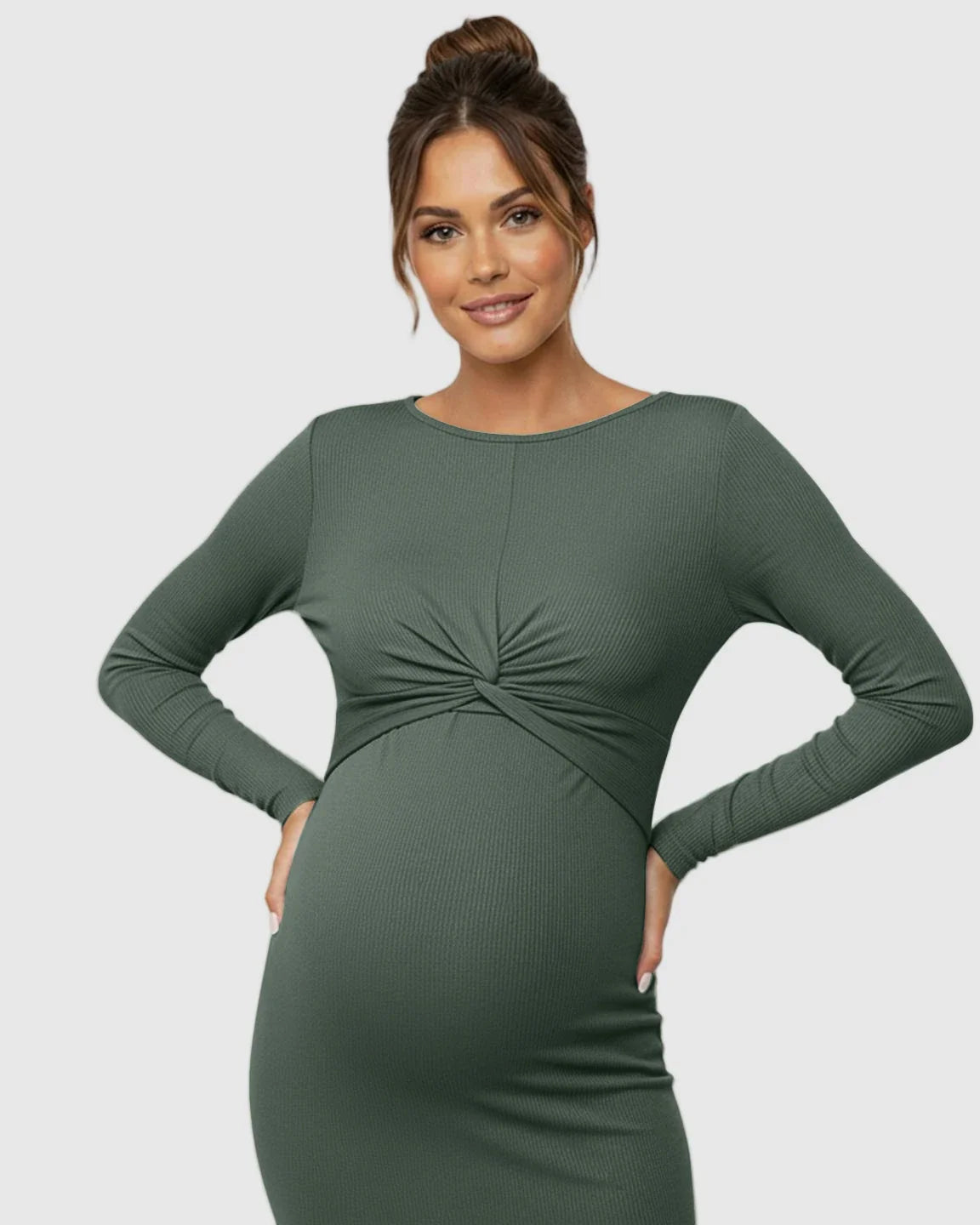Maternity model in a dark green ribbed bodycon dress with a twist-front detail and empire waist.
