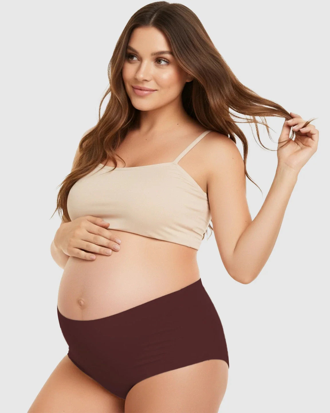 Pregnant woman wearing seamless high-waist support maternity underwear in a deep plum color.