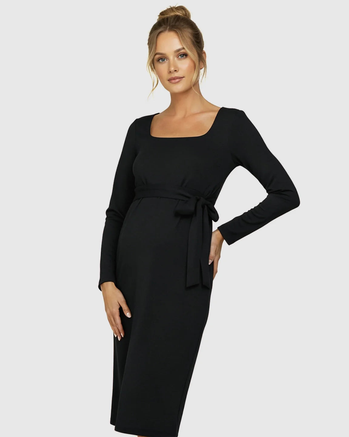 Pregnant woman in a black square neck, long-sleeve, side-tie bodycon maternity midi dress.