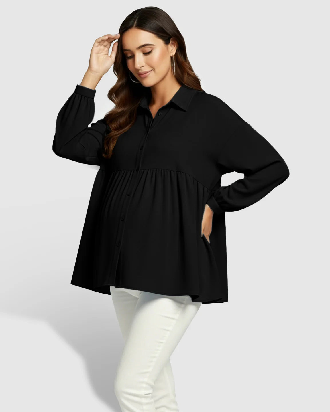 Woman in black chiffon Lapel Long Sleeve Maternity Shirt with babydoll fit, white pants.