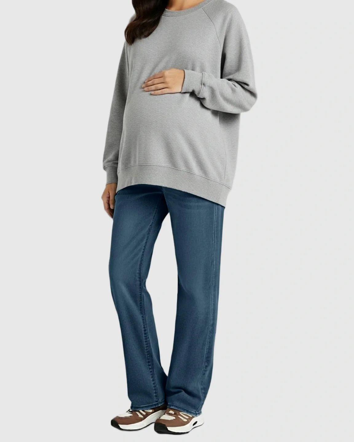 Pregnant woman in soft stretch straight-leg blue maternity jeans and a gray sweatshirt.