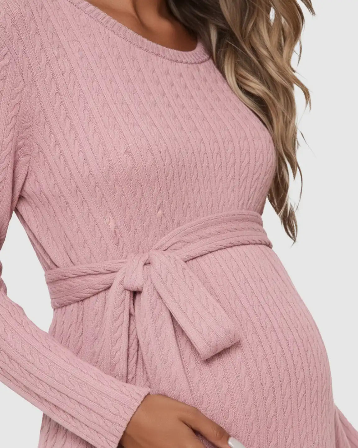Pink ribbed knit maternity midi dress with long sleeves, round neck, and tie-waist detail.