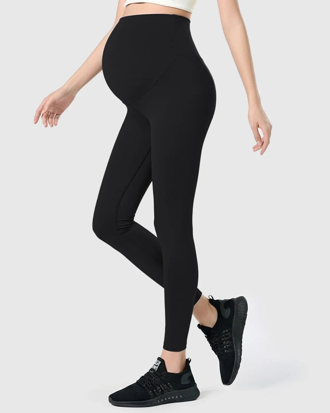 Black double-layer belly support maternity leggings on a model, showcasing the high-waisted design and stretch fabric.
