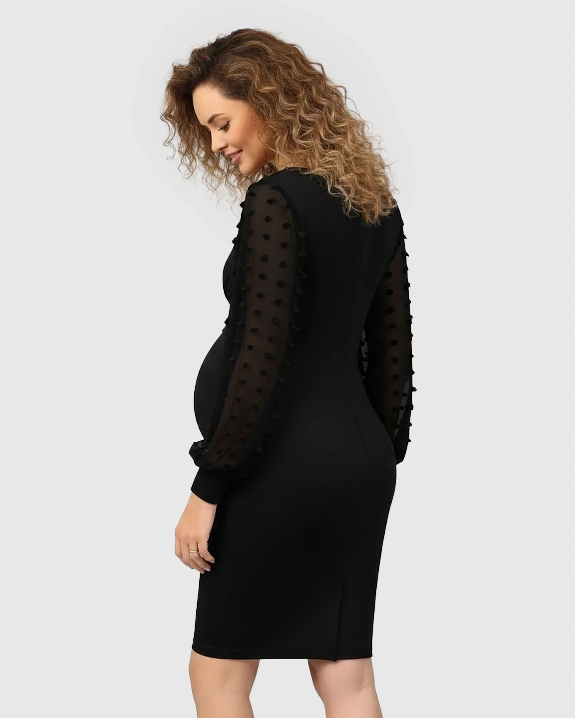 Black Swiss Dot Long Sleeve Formal Maternity Dress with V-neckline, shown on a pregnant woman.