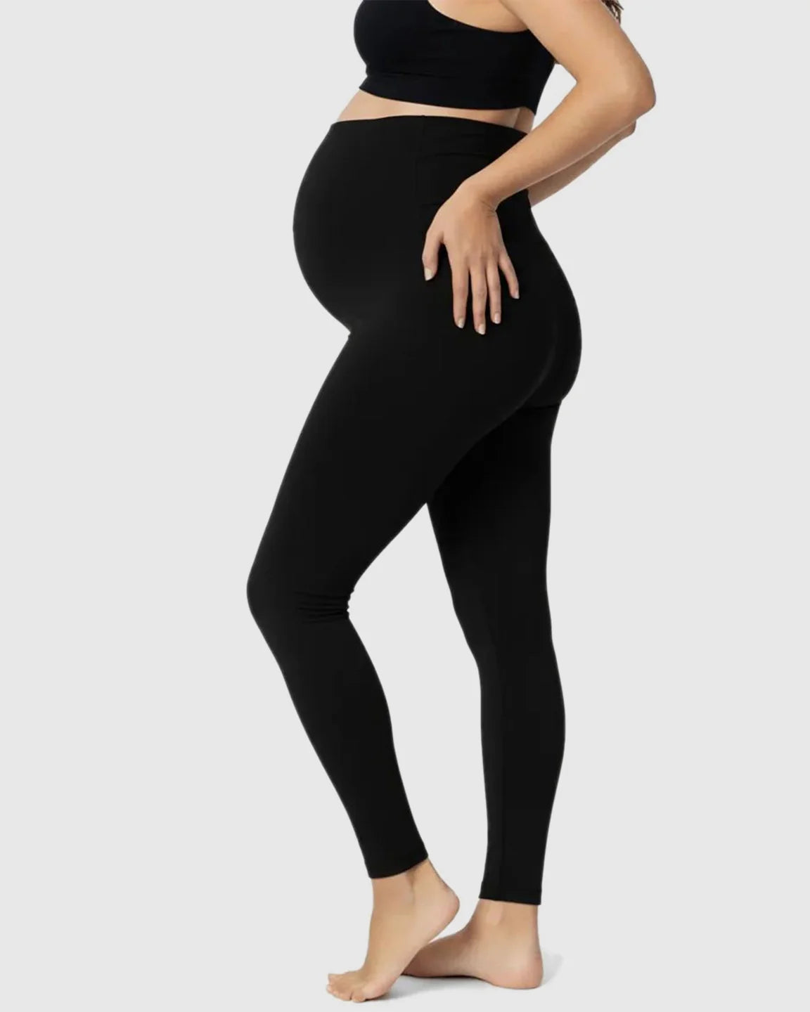 Pregnant woman wearing black Bump Society Belly Support Stretch Maternity Leggings with a high waist panel.