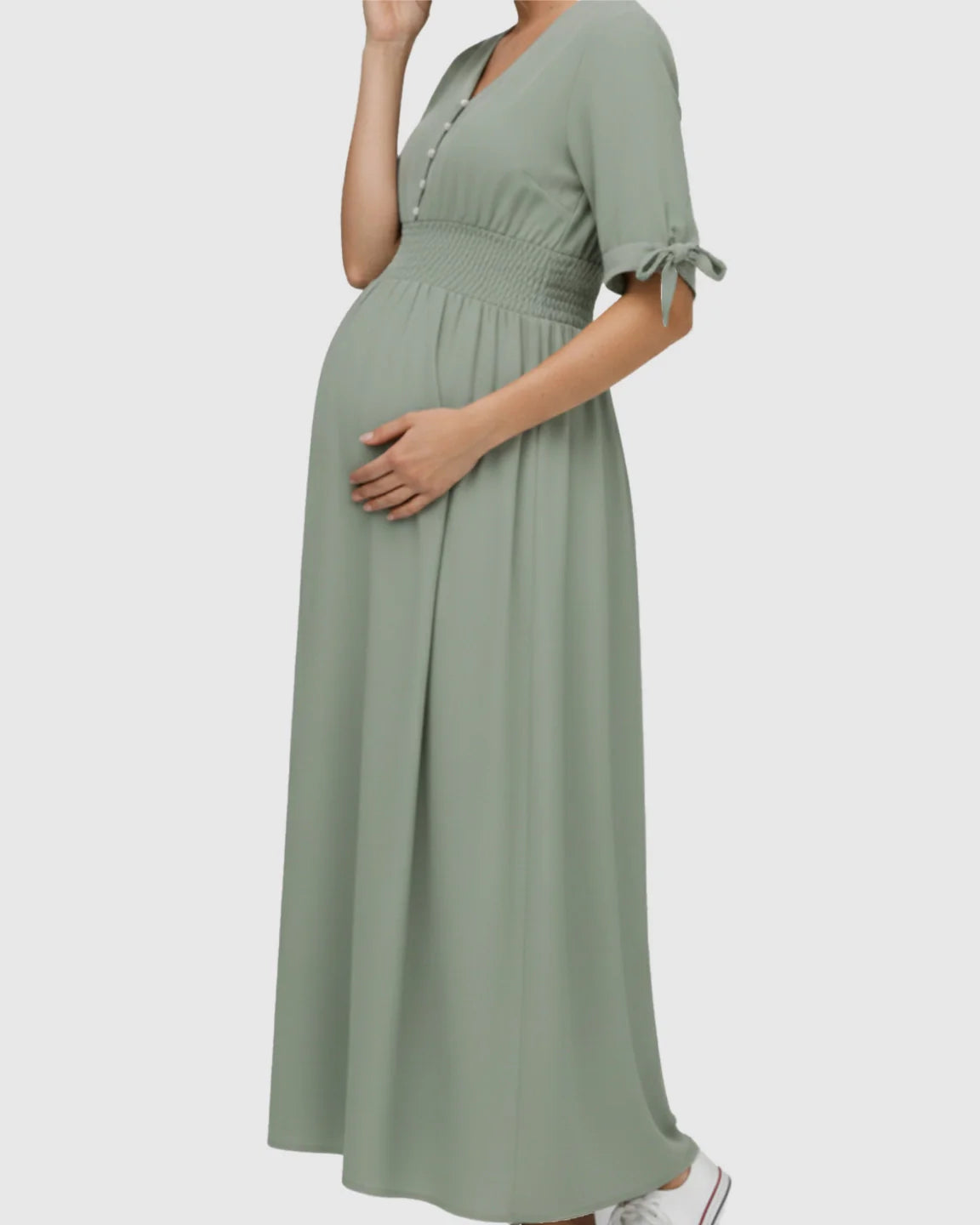 Mint green V-neck empire waist maternity maxi dress with buttons, smocked waist, and tied short sleeves.