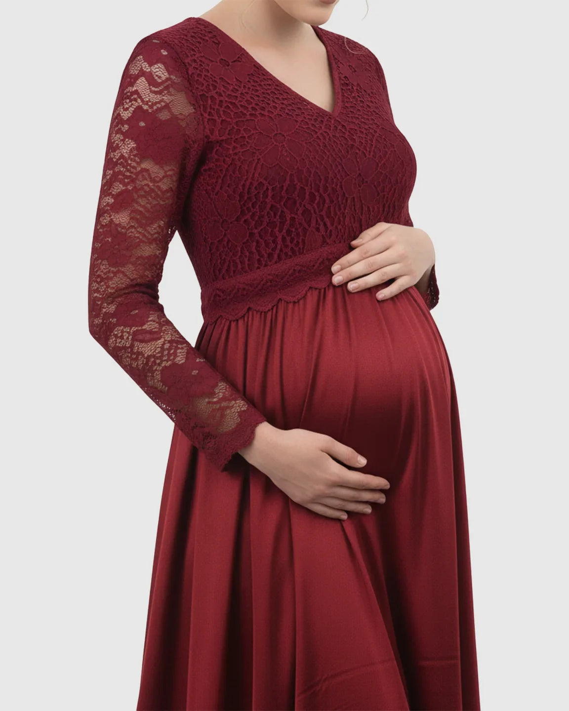 Red maternity maxi dress with lace-spliced V-neck bodice and long sleeves, flowing skirt.