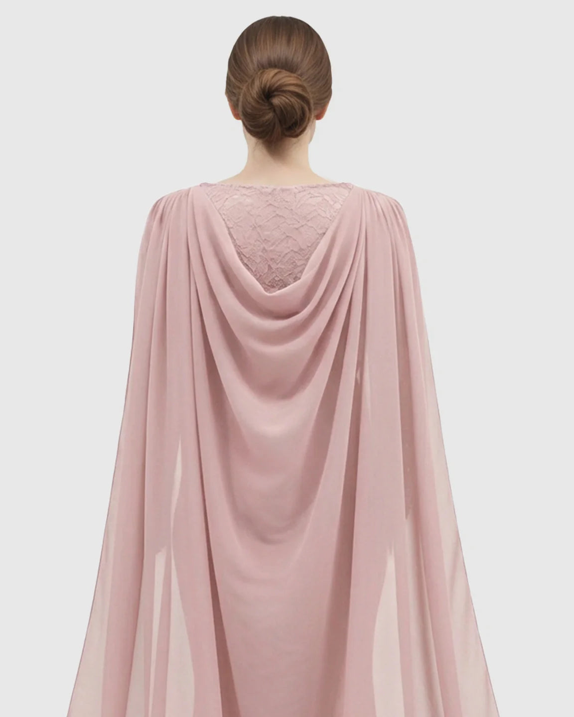 Back view of a pink chiffon and lace cape trailing maternity photography gown.