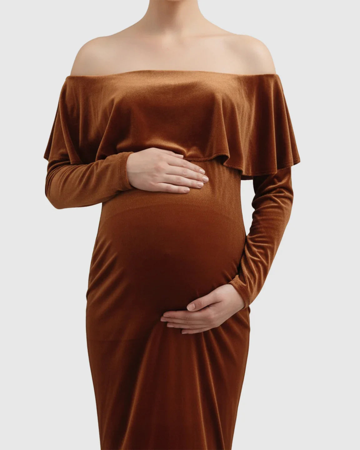 Velvet-touch elegant fitted maternity photoshoot gown in rich brown, off-shoulder with long sleeves.