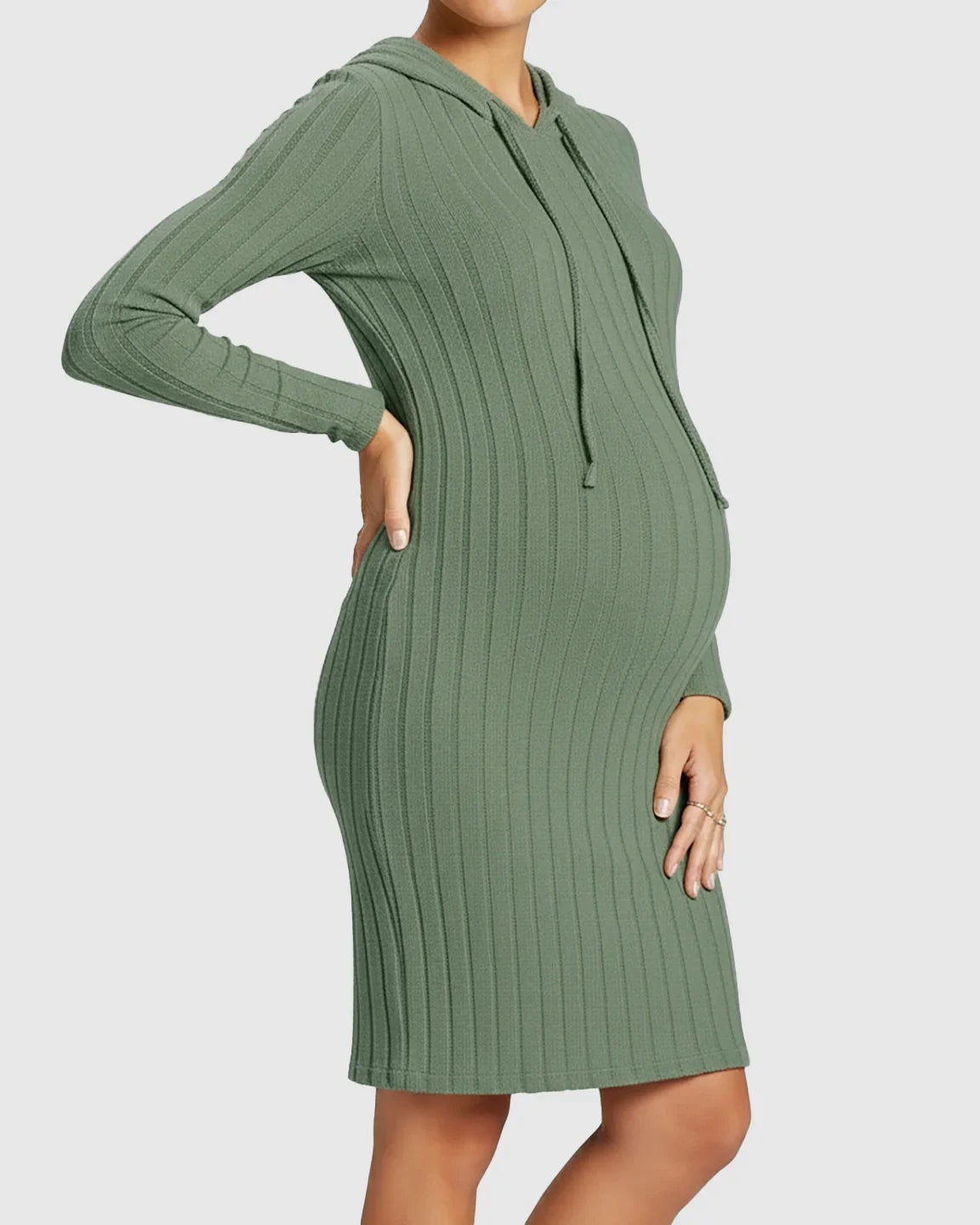 Pregnant woman in a green ribbed bodycon hooded maternity midi dress with long sleeves.