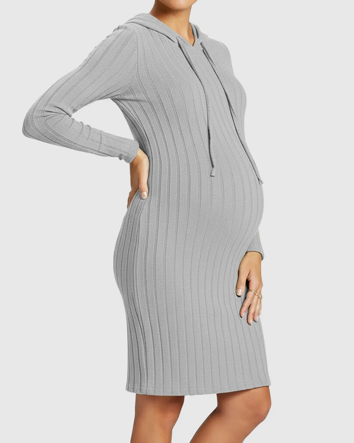 Pregnant woman in a grey ribbed bodycon hooded maternity midi dress with long sleeves and drawstring.