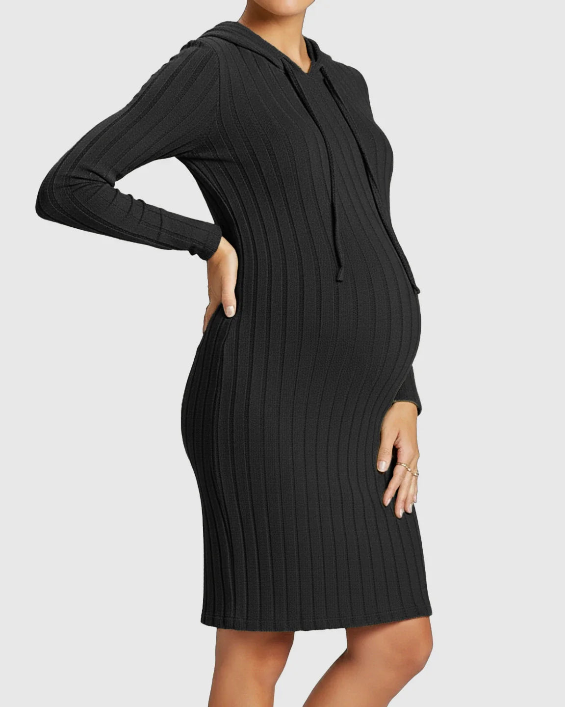Black ribbed bodycon hooded maternity midi dress with long sleeves, hugging a pregnant belly.