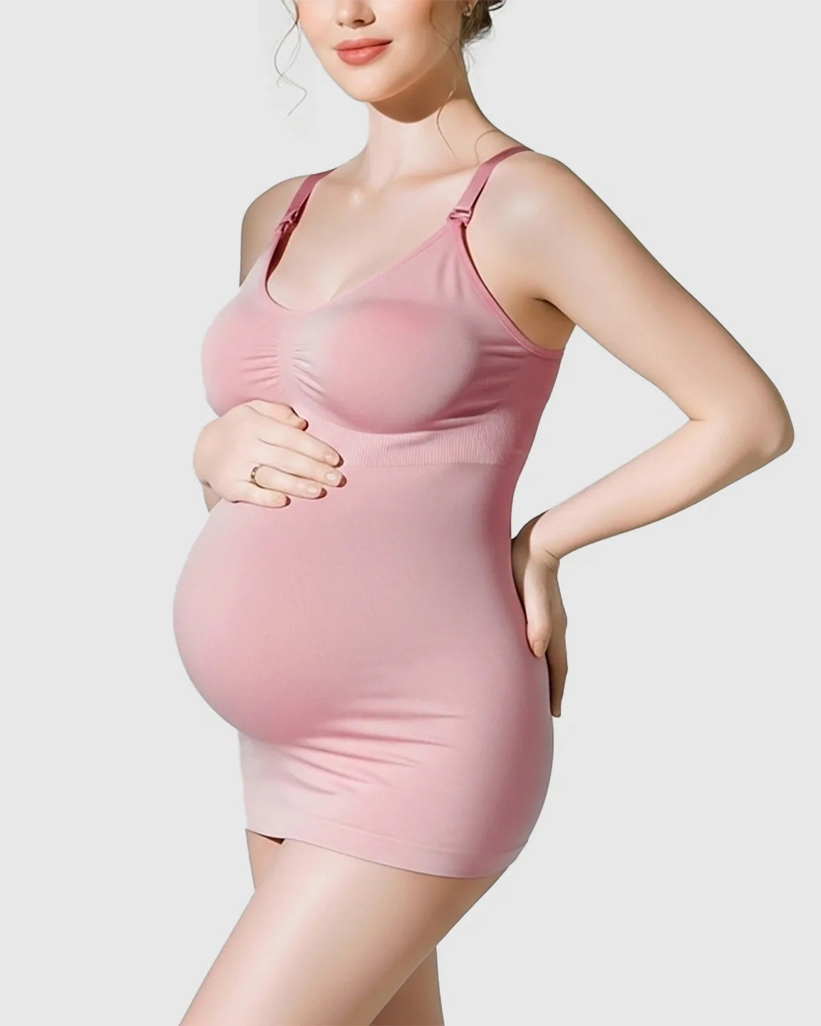 Pregnant model in a pink soft stretch front-opening wireless maternity nursing bra and matching tank top.