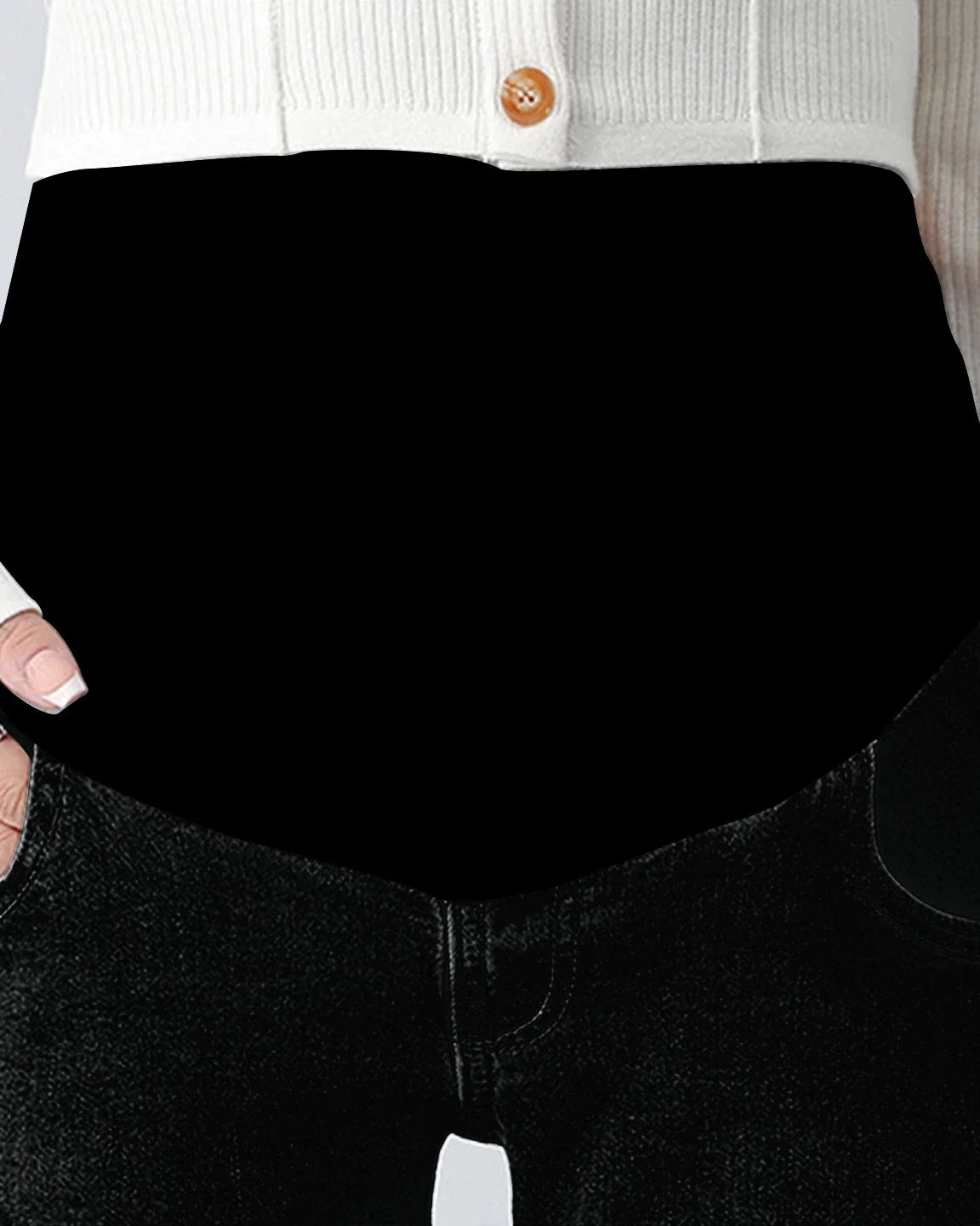 Black stretch denim straight-leg maternity jeans with a supportive over-the-belly panel, paired with a white cardigan.