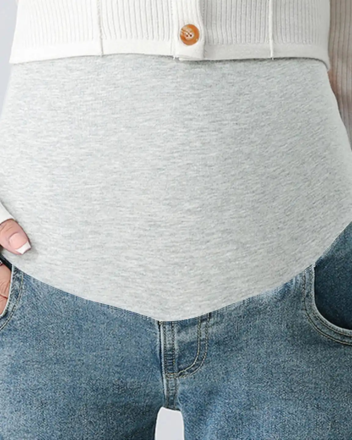 Close-up of light wash stretch denim straight-leg maternity jeans with a supportive grey comfort panel.