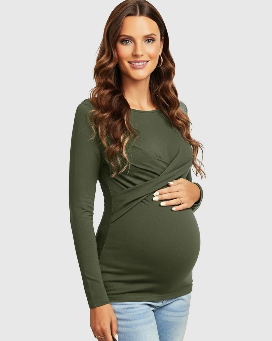 Smiling pregnant woman in a dark olive green cross-pleat fitted long sleeve maternity top.