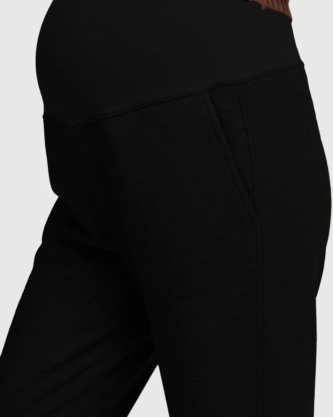 Black soft knit maternity joggers with a supportive waistband and side pockets, designed for comfort.