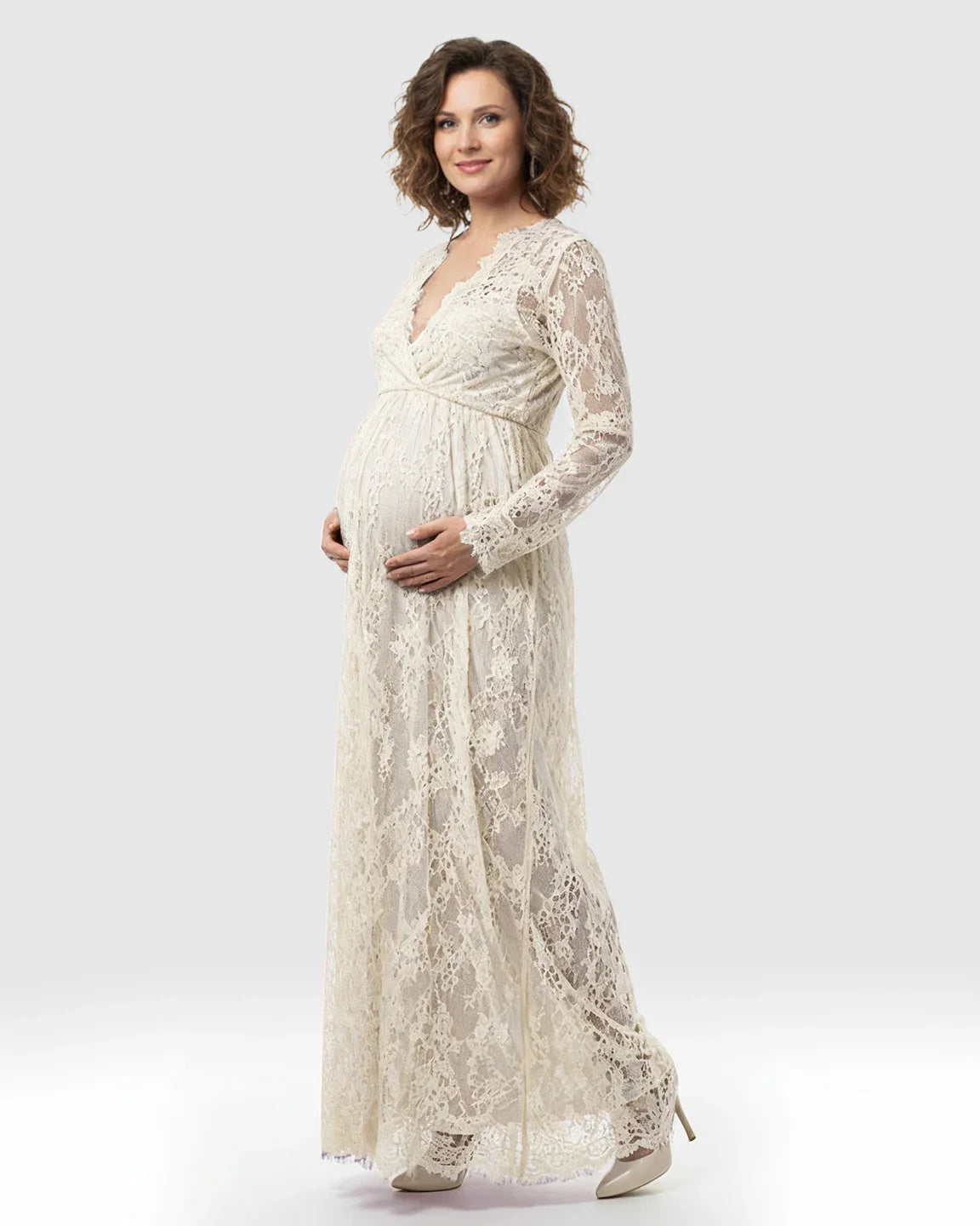 Sheer floral lace empire waist maternity maxi dress in cream, with long sleeves and a V-neck.