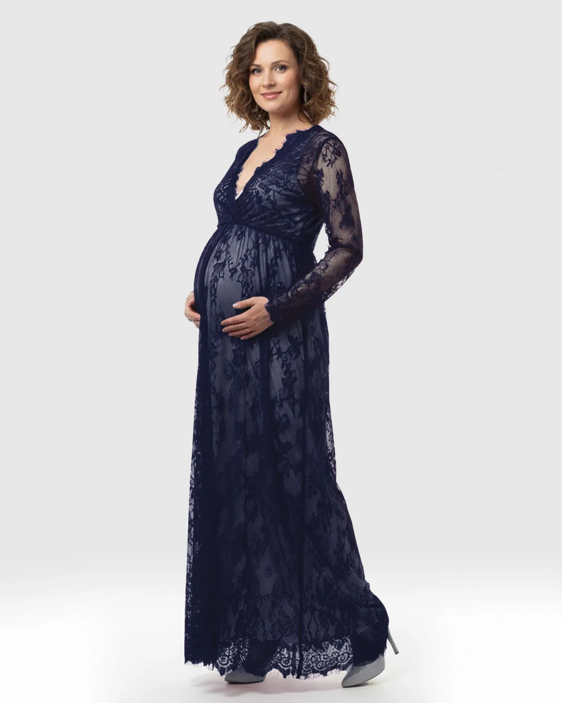 Navy sheer floral lace maternity maxi dress with empire waist and long sleeves, worn by a pregnant woman.