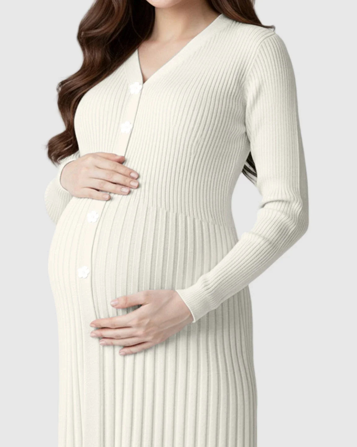 Maternity model in a cream ribbed knit midi dress with long sleeves, V-neck, and white buttons.
