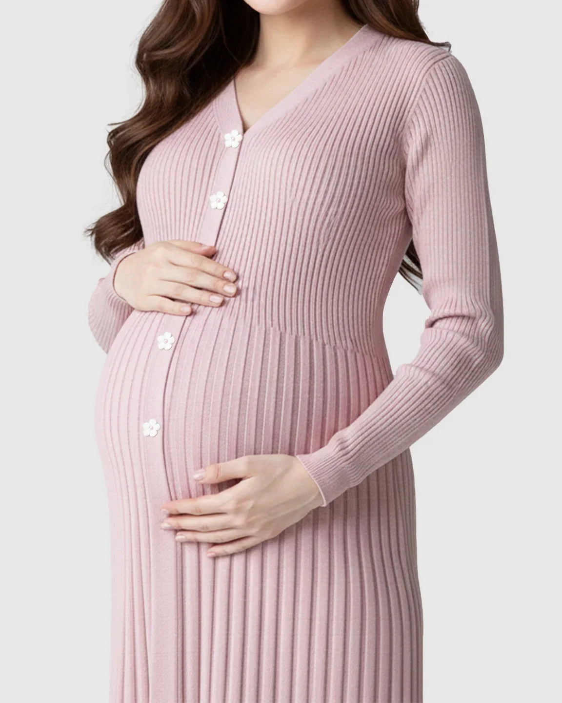 Maternity midi dress in pink ribbed knit with long sleeves, V-neck, and white flower buttons.