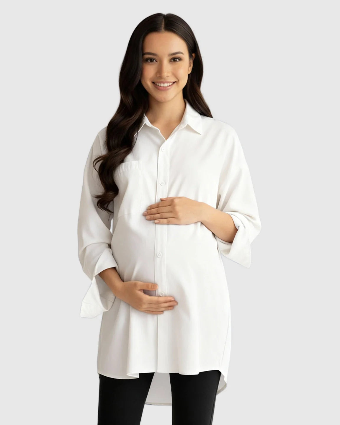 Smiling pregnant woman in a white cotton lapel-collar button-front maternity tunic.