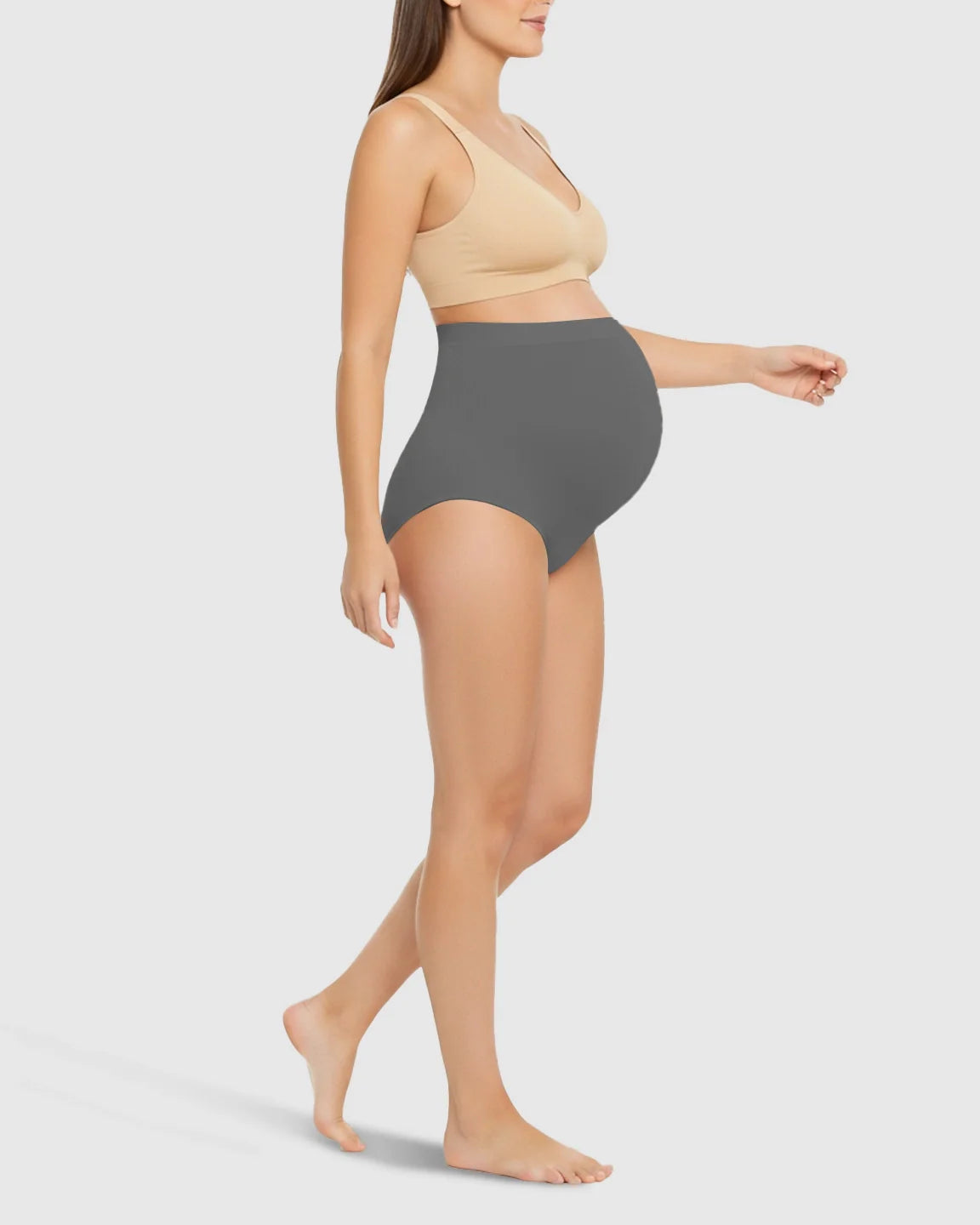 Woman wearing Bump Society high-waist seamless charcoal grey maternity underwear with belly support.