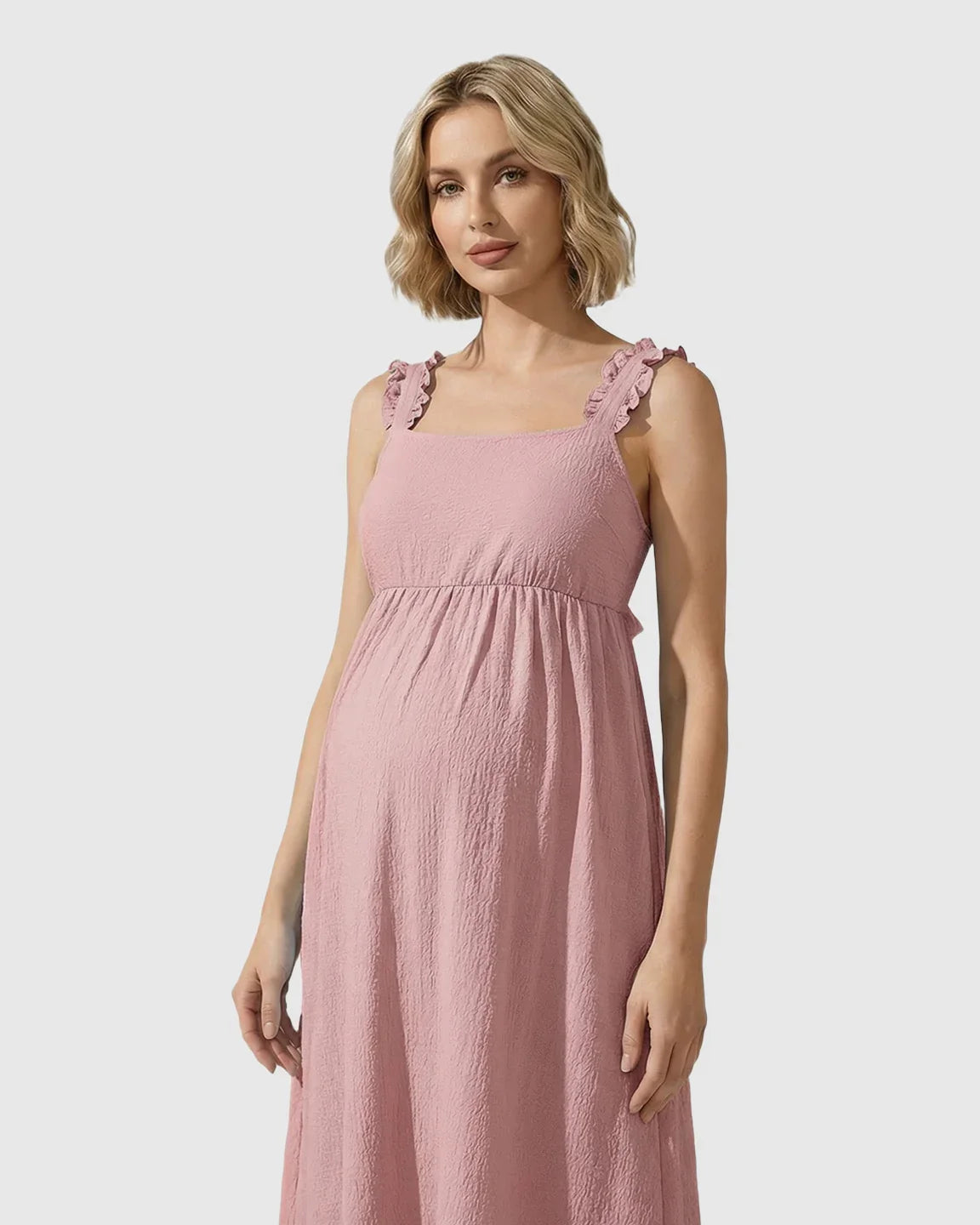 Maternity maxi dress in pink with ruffled straps, square neckline, empire waist, and tiered skirt.