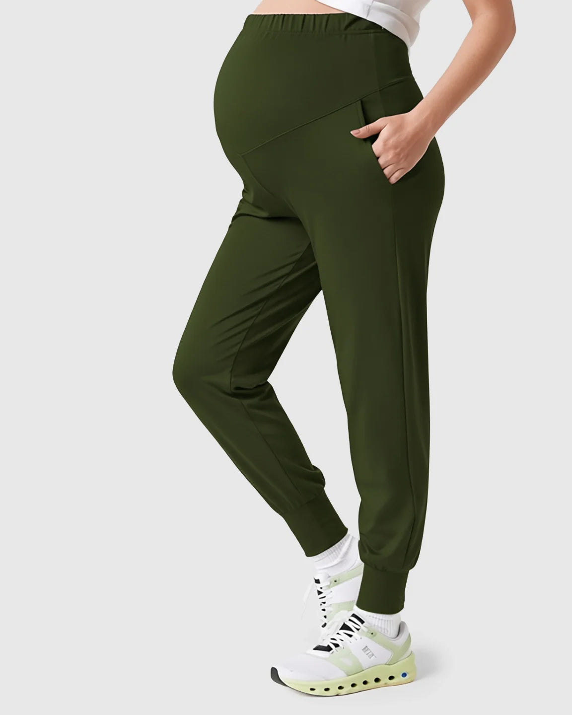 Olive green supportive slim-fitting maternity joggers with a high-waist design and side pockets.