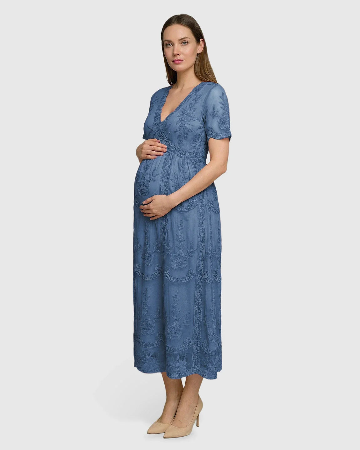Pregnant woman in a blue lace maternity midi dress with V-neck, three-quarter sleeves, and swing skirt.