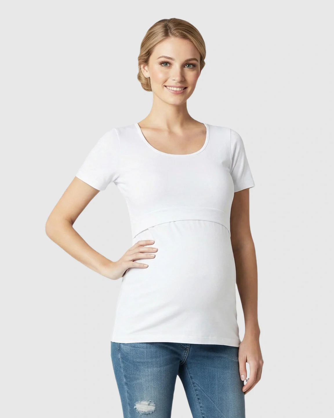 Smiling woman models a white stretch-fit V-neck nursing t-shirt with short sleeves and easy access.