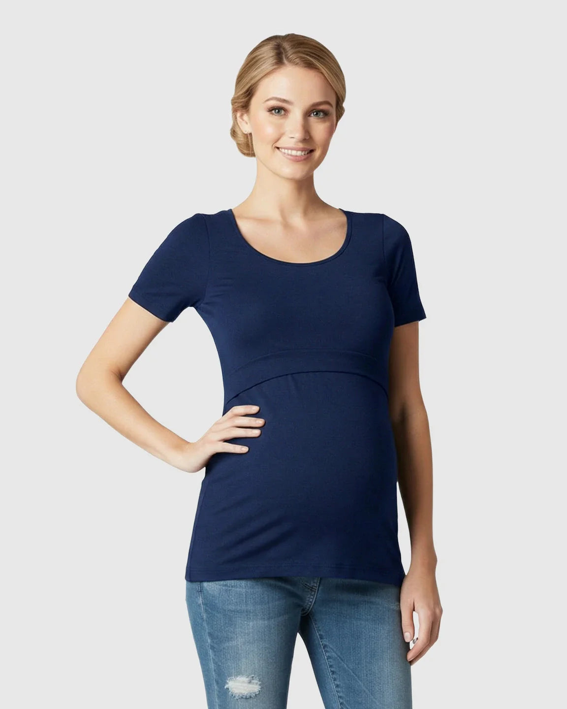 Smiling pregnant woman in a navy stretch-fit scoop-neck nursing t-shirt and jeans.