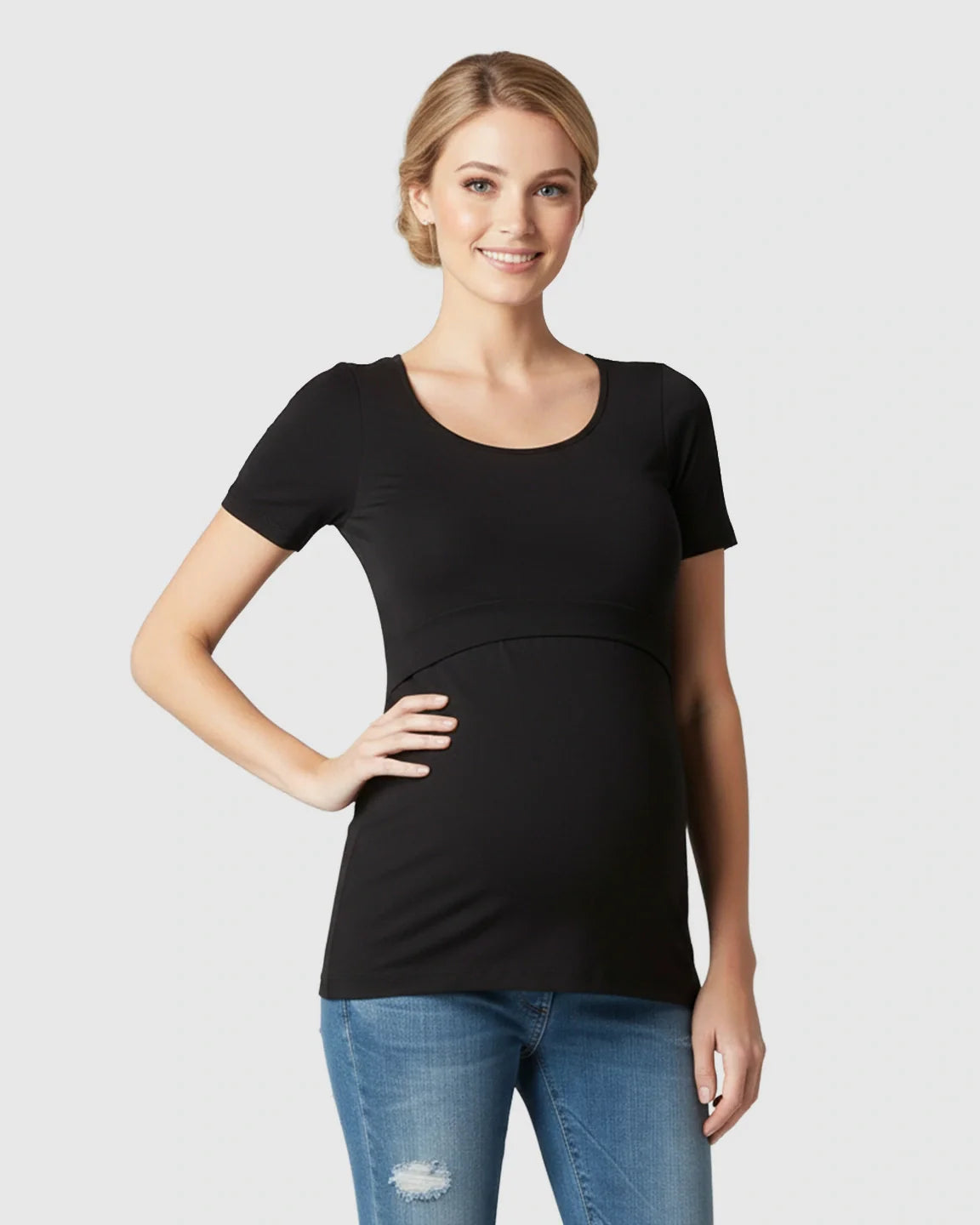 Smiling woman models a black stretch-fit V-neck nursing t-shirt with easy breastfeeding access.