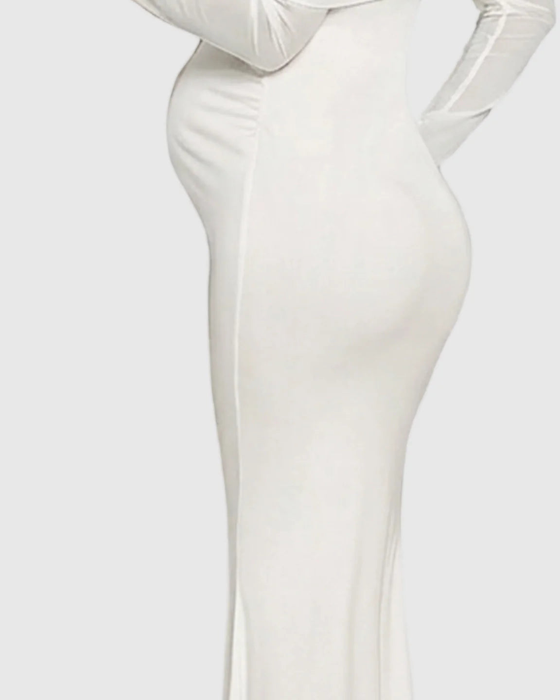 White draped neck mermaid fit maternity maxi dress, showcasing a pregnant belly and long sleeves.