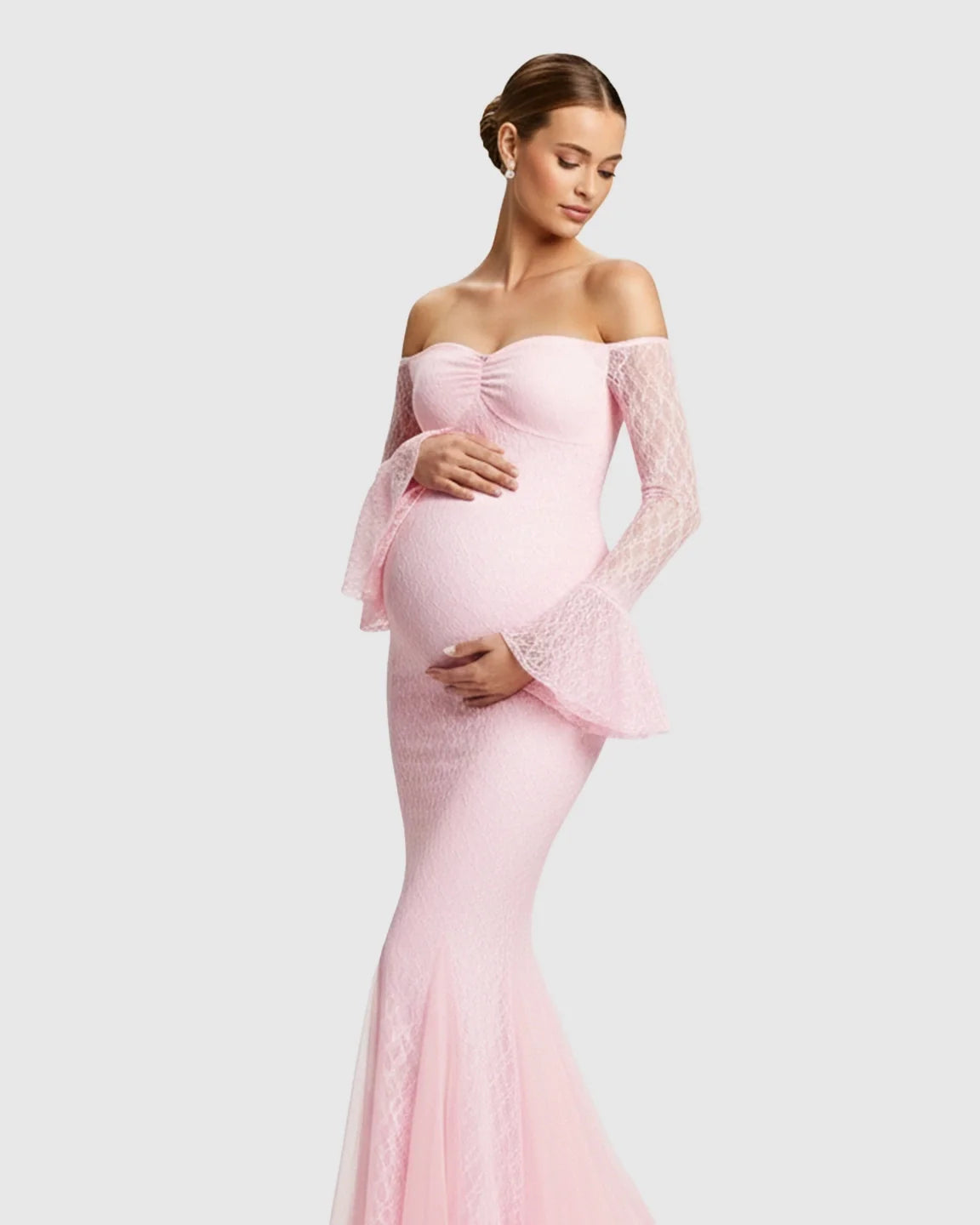 Pregnant woman in a pink off-shoulder lace mermaid maternity maxi dress with bell sleeves.