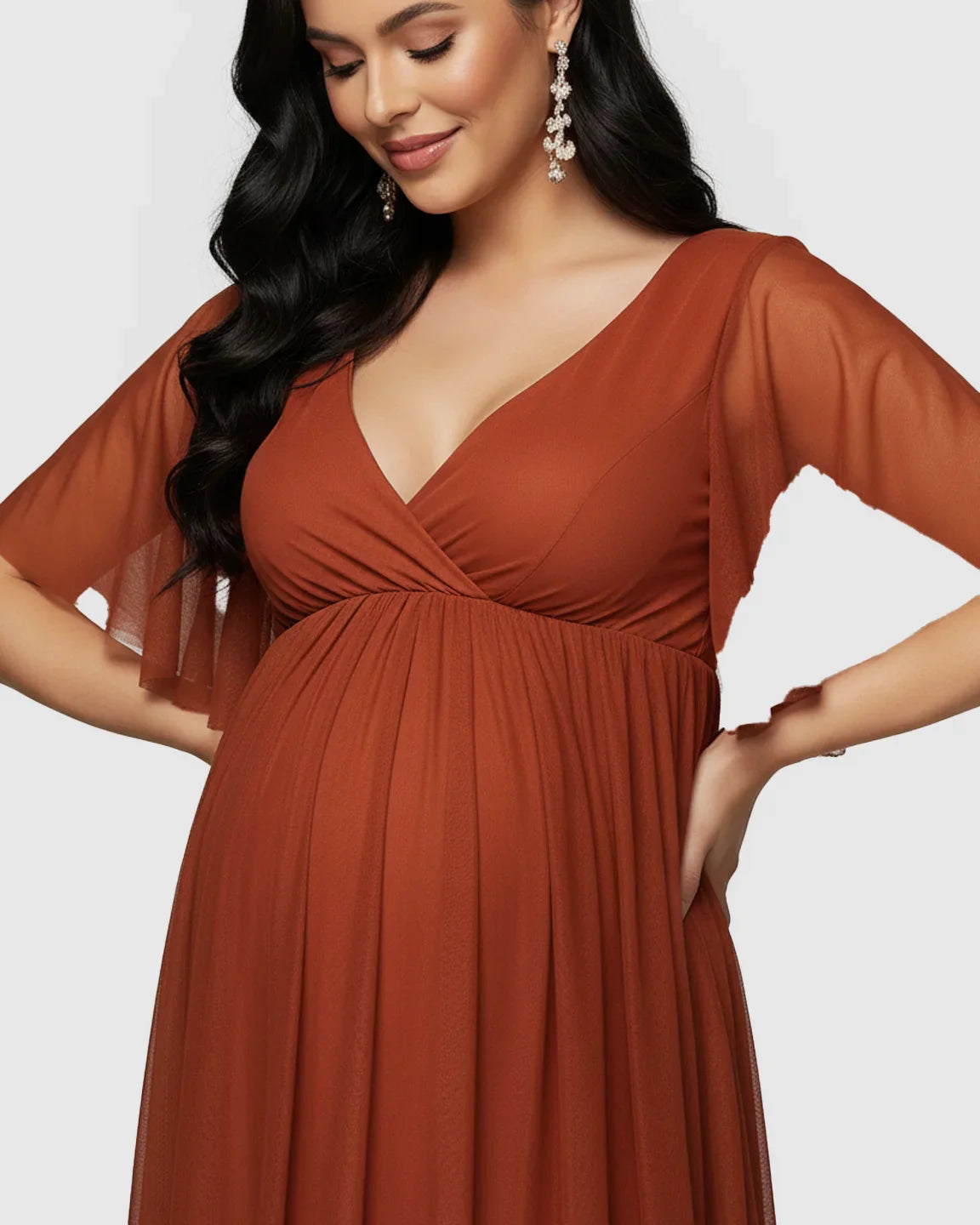 Maternity maxi dress in rust chiffon, featuring a V-neck, empire waist, and flutter sleeves.