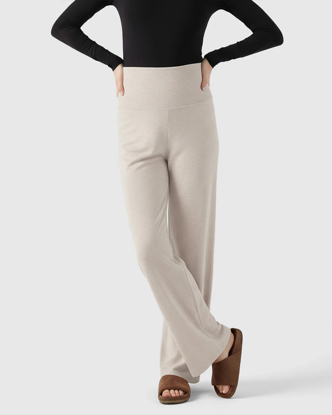 Light beige fleece relaxed maternity pants with an over-belly waistband and wide-leg silhouette.