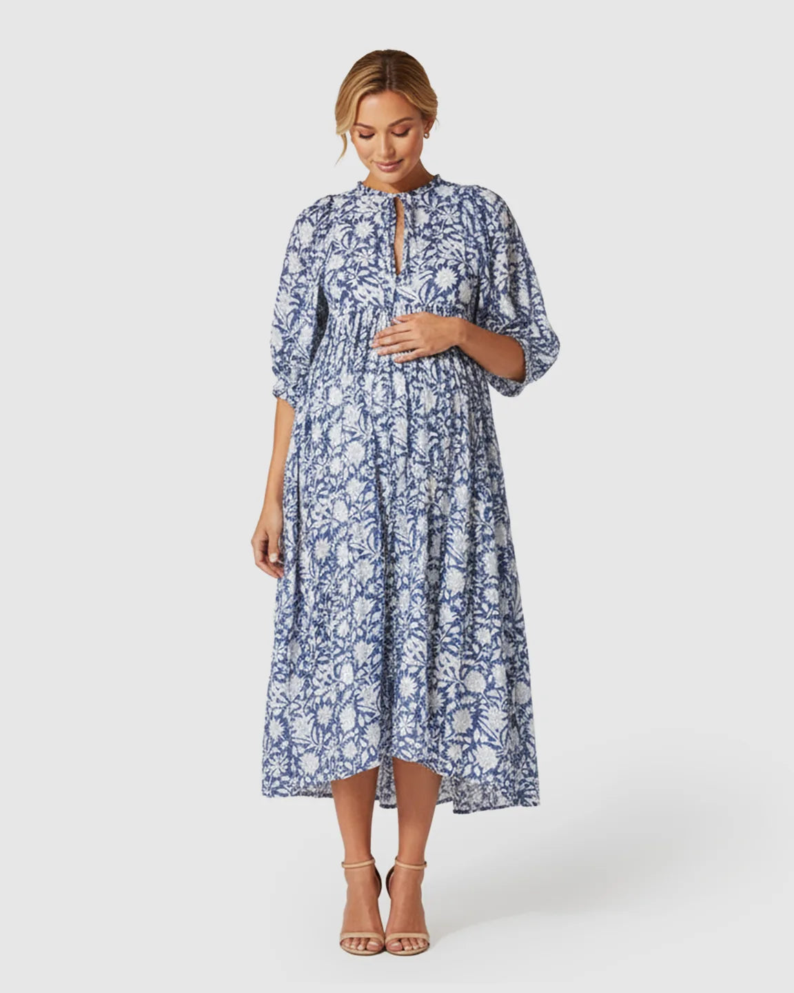 Maternity midi dress in blue and white floral print with gathered shoulders, puff sleeves, and a relaxed fit.