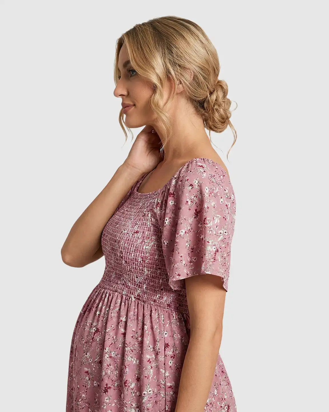 Maternity midi dress in pink floral print with flutter sleeves and smocked bodice.