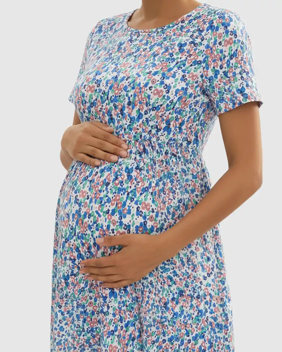 Maternity maxi dress with a flowy floral-pastoral print, round neckline, short sleeves, and chiffon fabric.