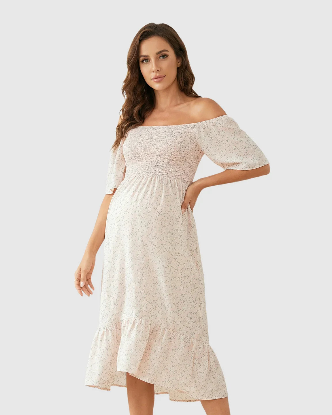 Maternity midi dress with flutter sleeves, smocked top, and tiered skirt in a light floral print.