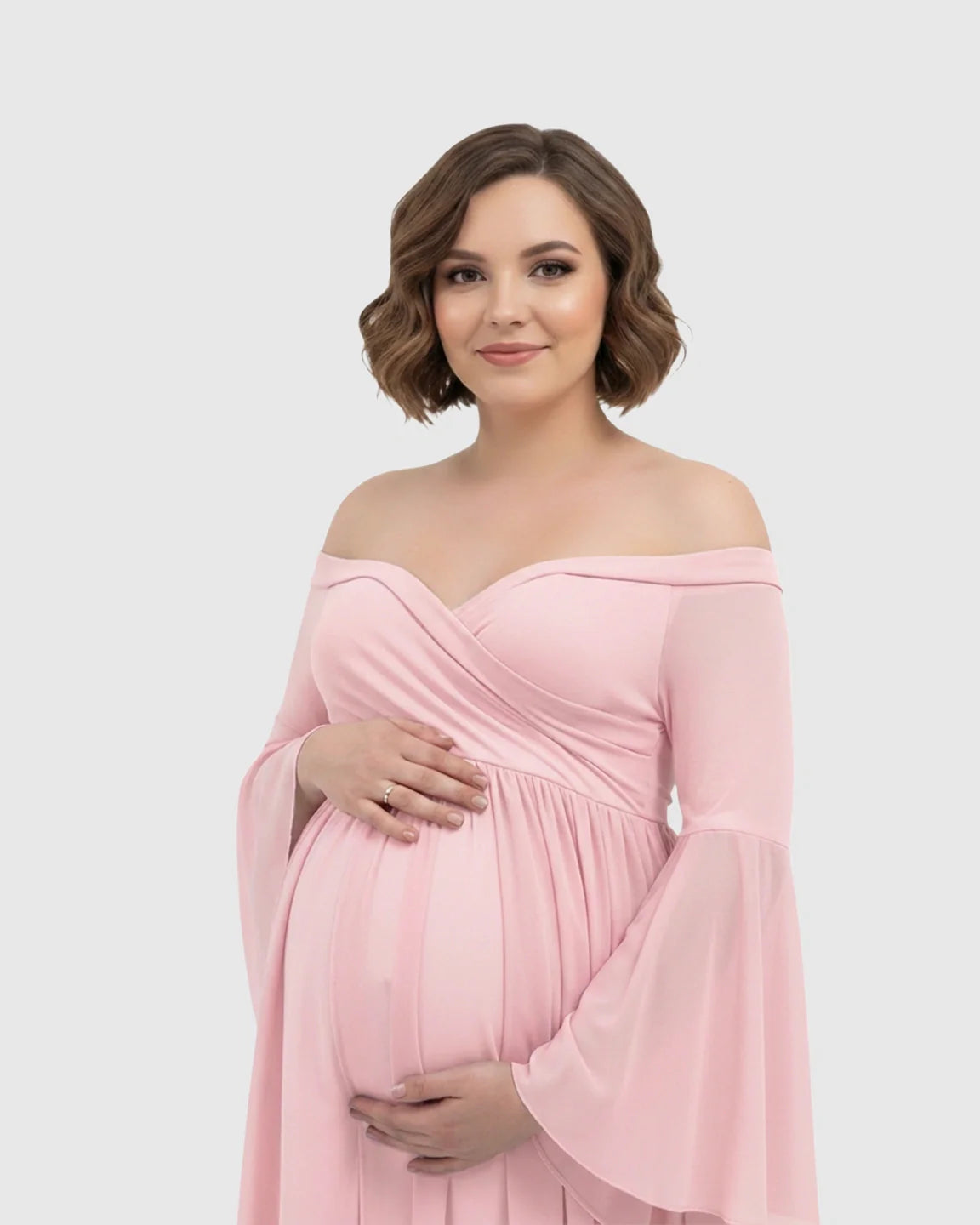 Pink off-shoulder maternity gown with bell sleeves, flowing chiffon, and a long train.