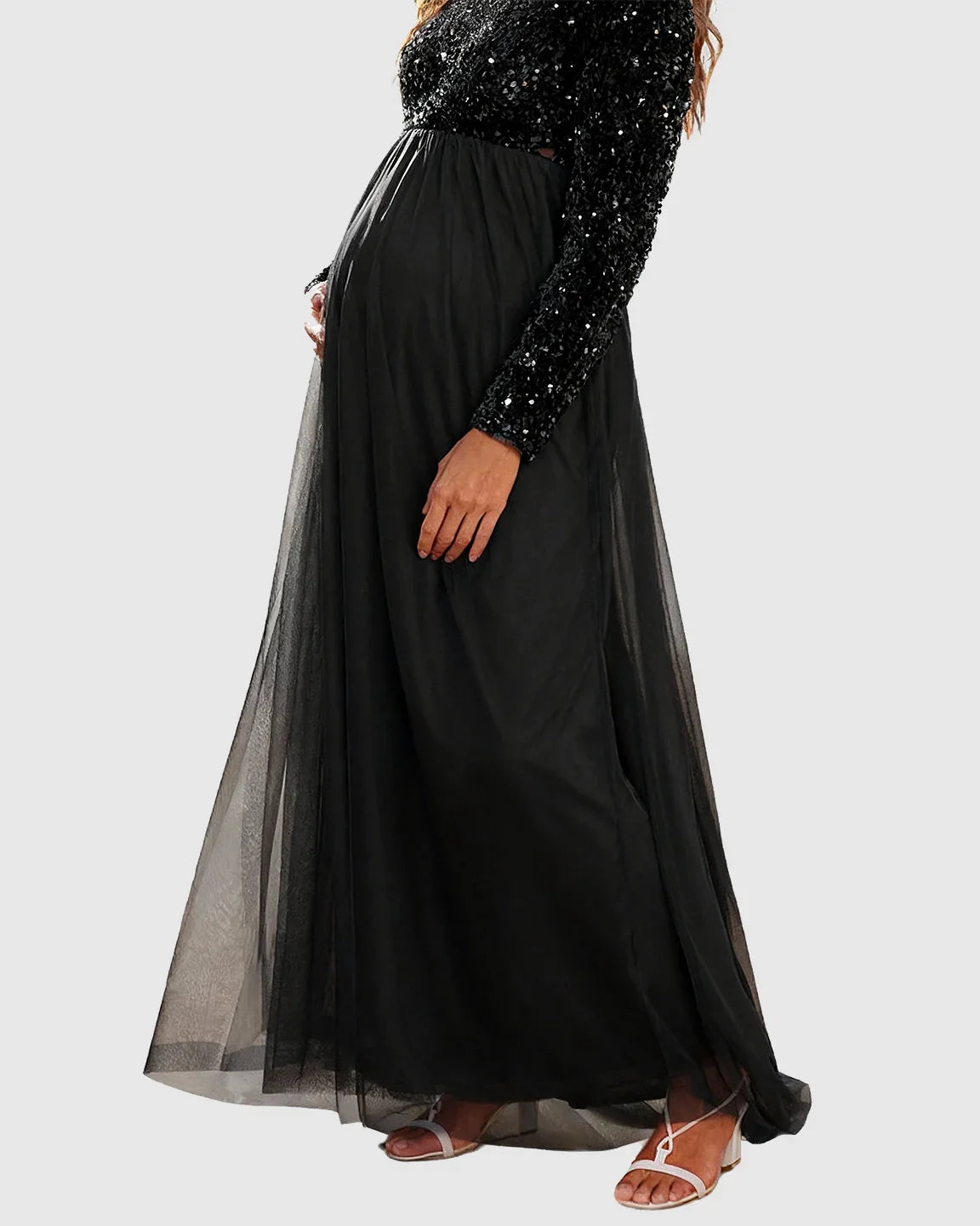 Black sequin long-sleeve empire waist maternity maxi dress with flowing mesh skirt.