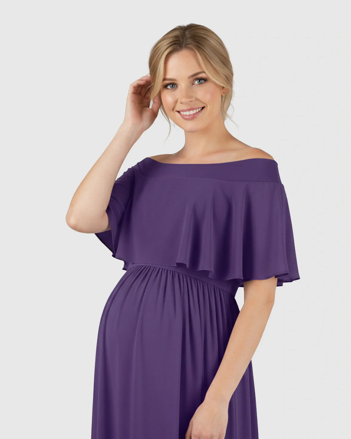 Smiling pregnant woman in a flowing purple off-shoulder chiffon maternity photoshoot dress.