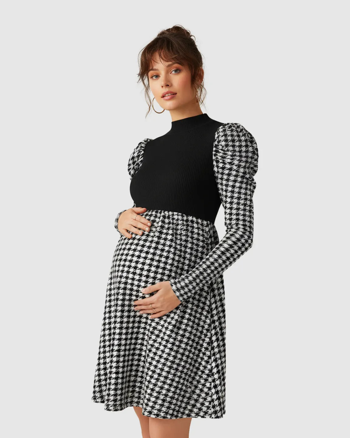 Elegant maternity short dress with black knit bodice, houndstooth skirt, and puff sleeves.