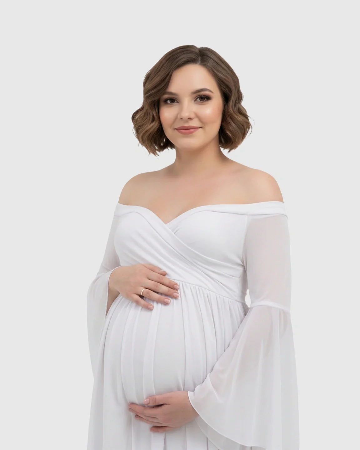 White off-shoulder maternity gown with bell sleeves, flowing chiffon, and a long train.